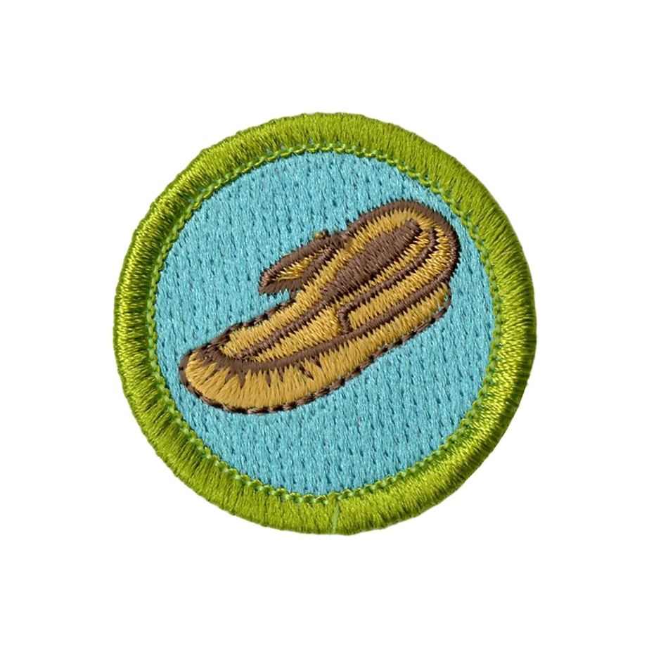 Leatherwork Merit Badge Emblem featuring leather moccasin on blue background with green border.