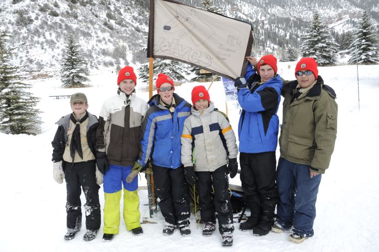 Scouts from a pack pose for a picture in winter camping gear