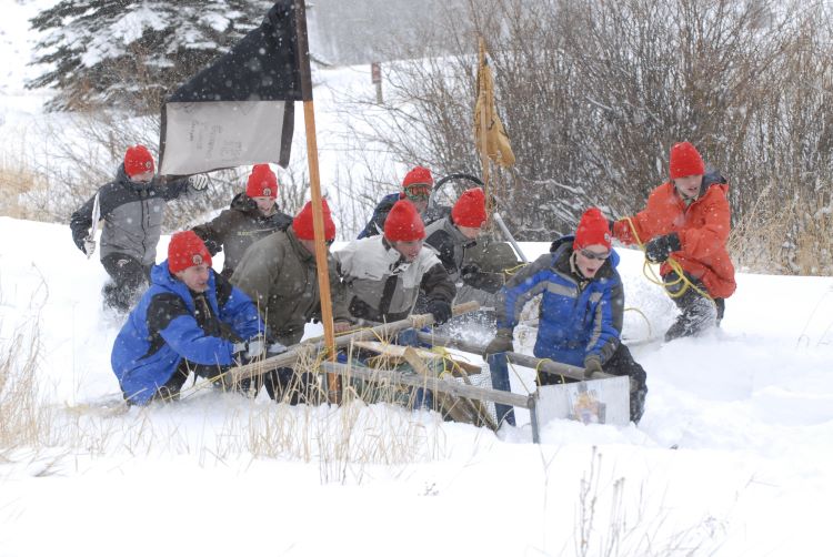 Scouts playing in the snow during a winter campout